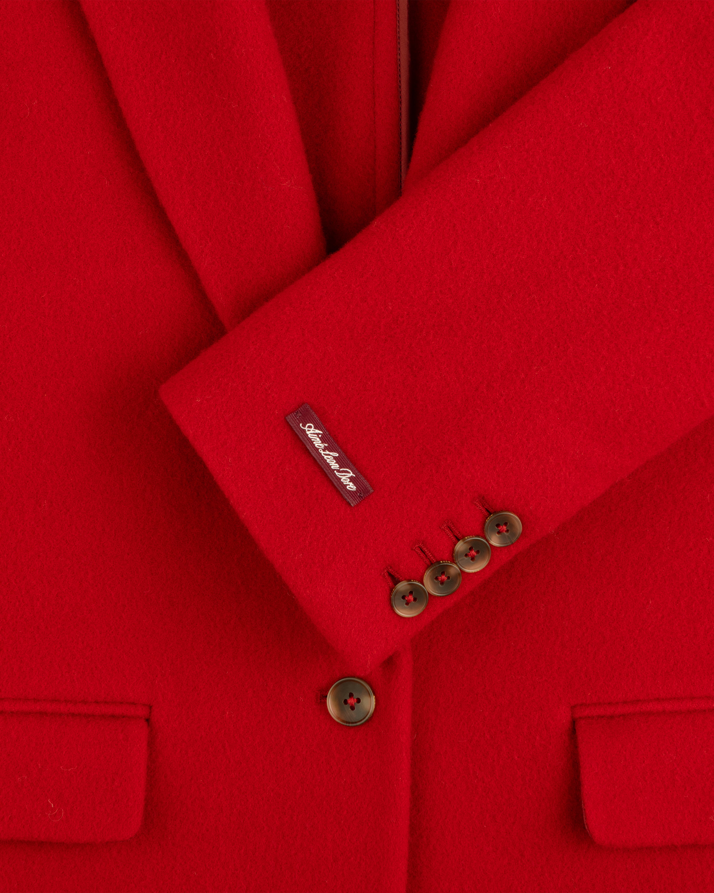 Bright red Wool Sportcoat with four buttons on the cuff and a label on the sleeve.