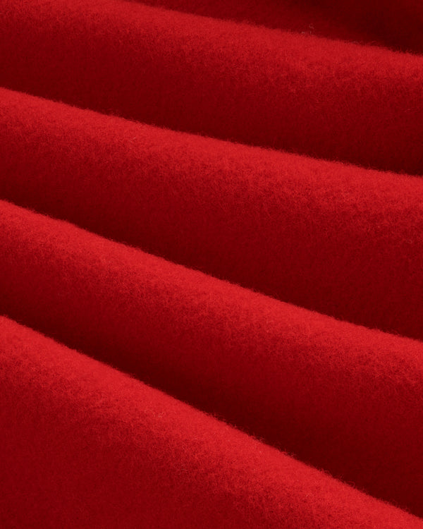 Close-up of red felted Wool Sportcoat fabric with diagonal folds.