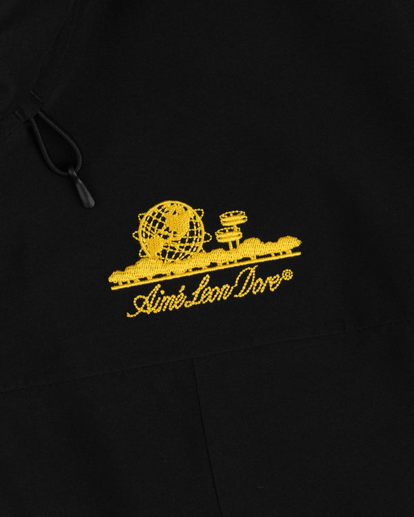 Black Cropped GORE-TEX Shell Jacket with a yellow globe and tower graphic above the text Aimé Leon Dore.