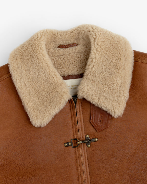 Shearling Bomber Jacket in brown leather with a tan shearling collar and a metal toggle closure.