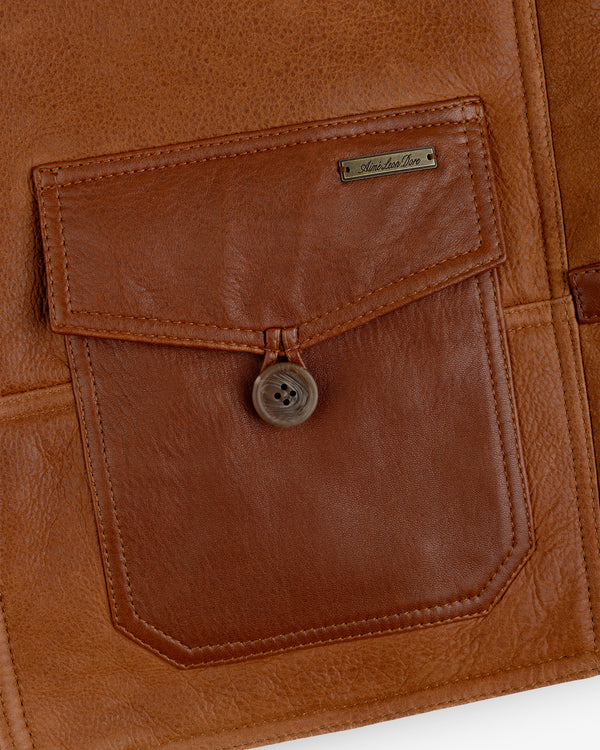 Brown leather Shearling Bomber Jacket pocket with a single button flap and a small metal nameplate.