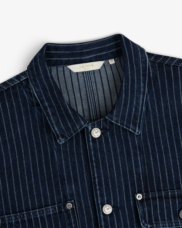Chalk Stripe Denim Trucker Jacket in dark blue with white stripes, silver buttons, and two front pockets shown close up.