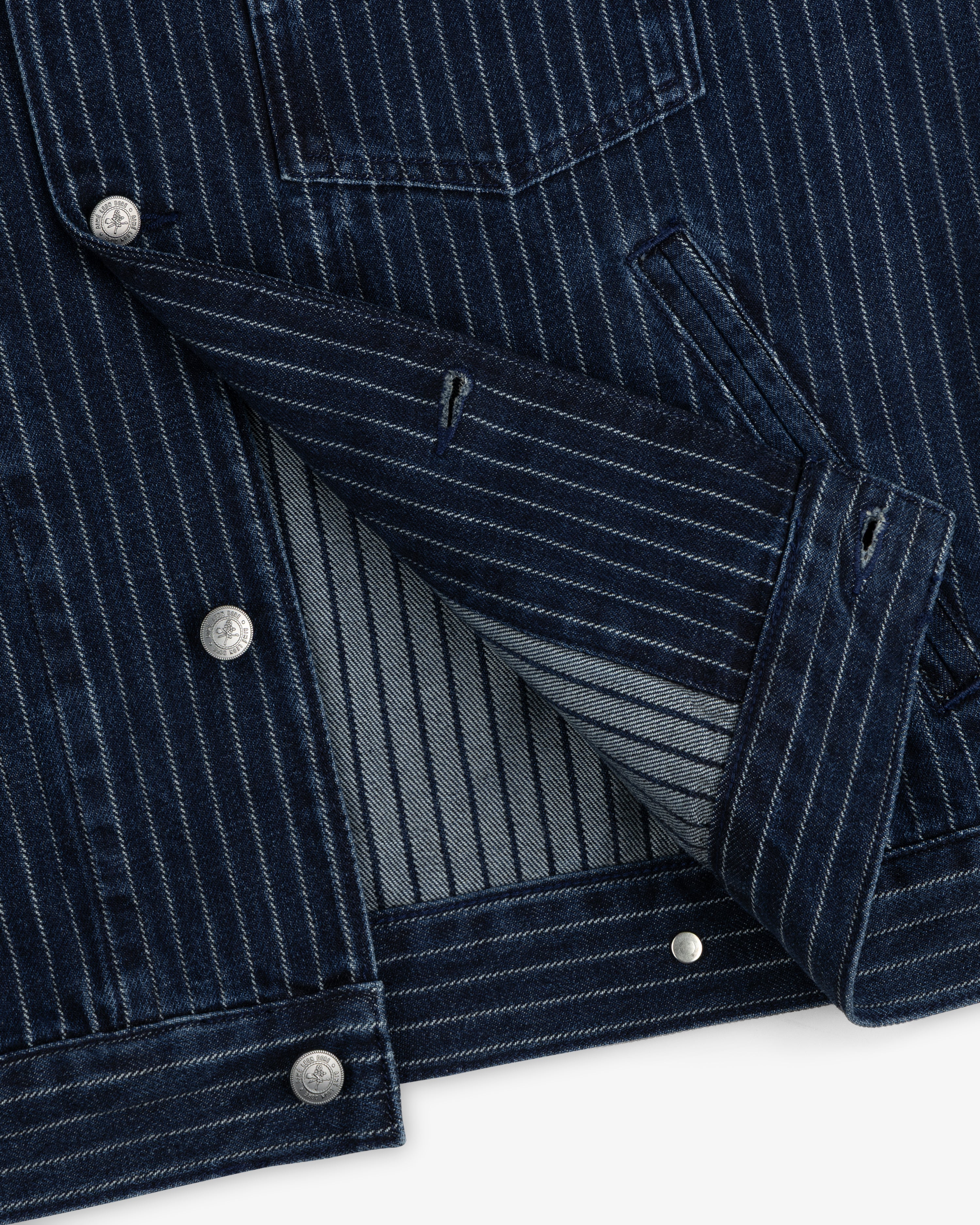 Chalk Stripe Denim Trucker Jacket with silver buttons, front pocket, and exposed inner lining.