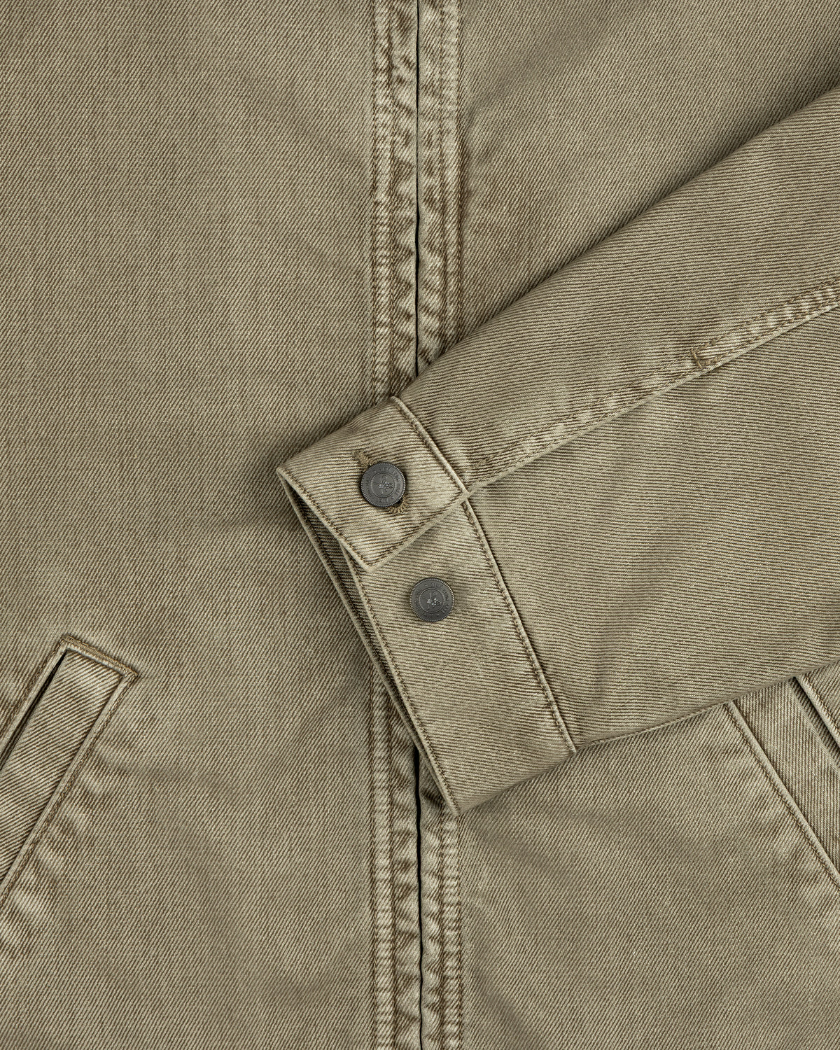 Olive green Flocked Denim Jacket sleeve with buttoned cuffs and two pockets.