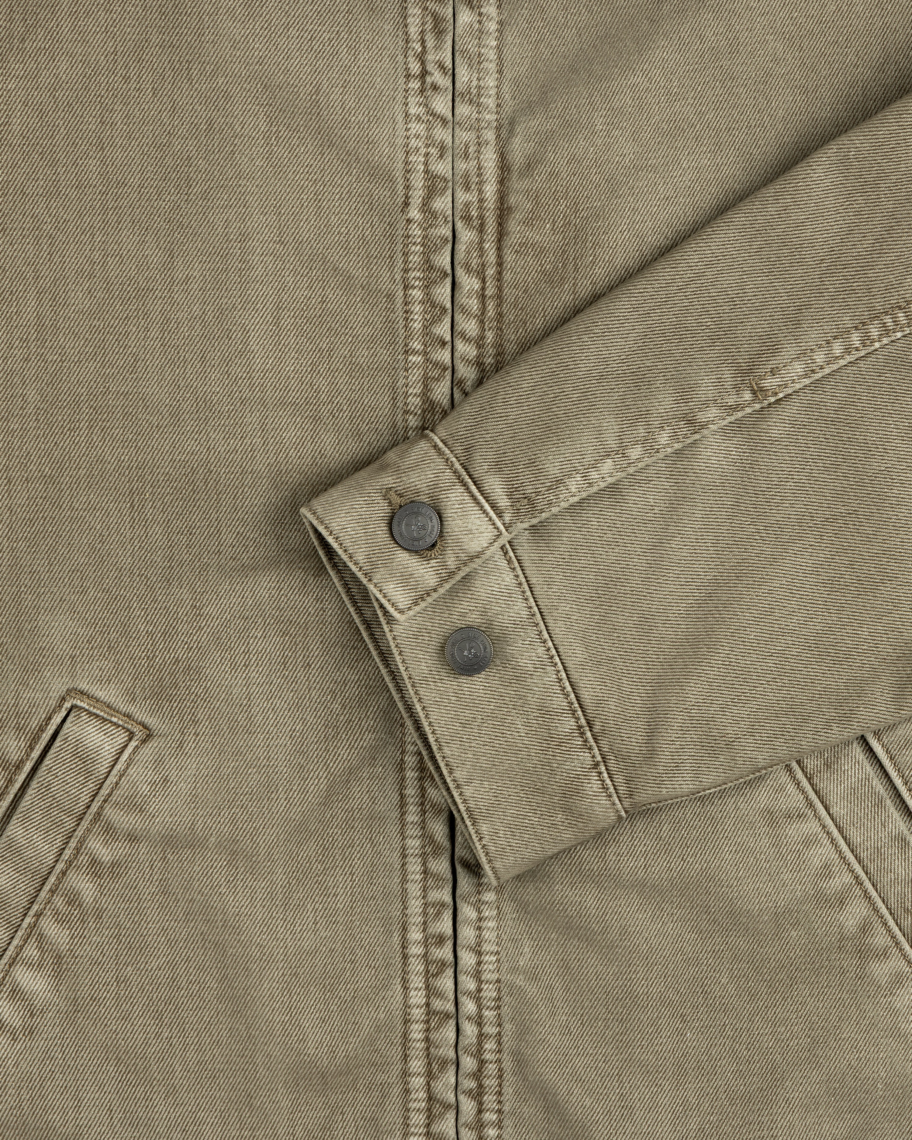 Olive green Flocked Denim Jacket sleeve with buttoned cuffs and two pockets.