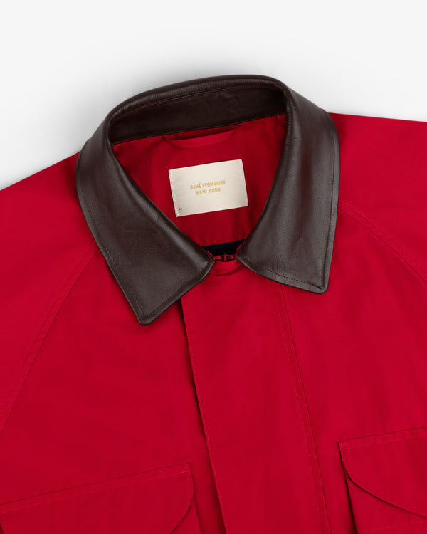Lightweight Barn Jacket in red with a brown leather collar, two front pockets, and a visible inner label.