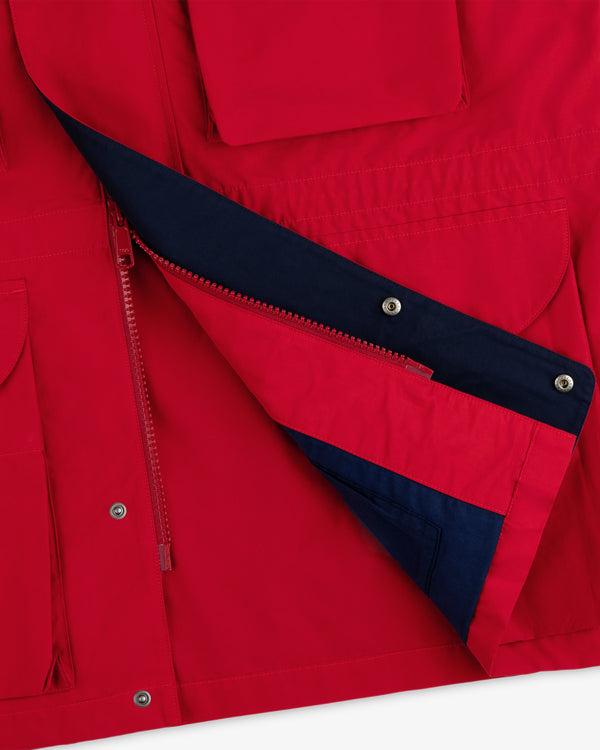 Lightweight Barn Jacket, partially unzipped to show a navy lining and featuring multiple exterior pockets.