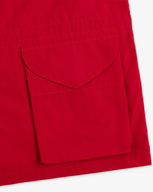 Close-up of the Lightweight Barn Jacket’s red fabric with a large rectangular flap pocket stitched on.