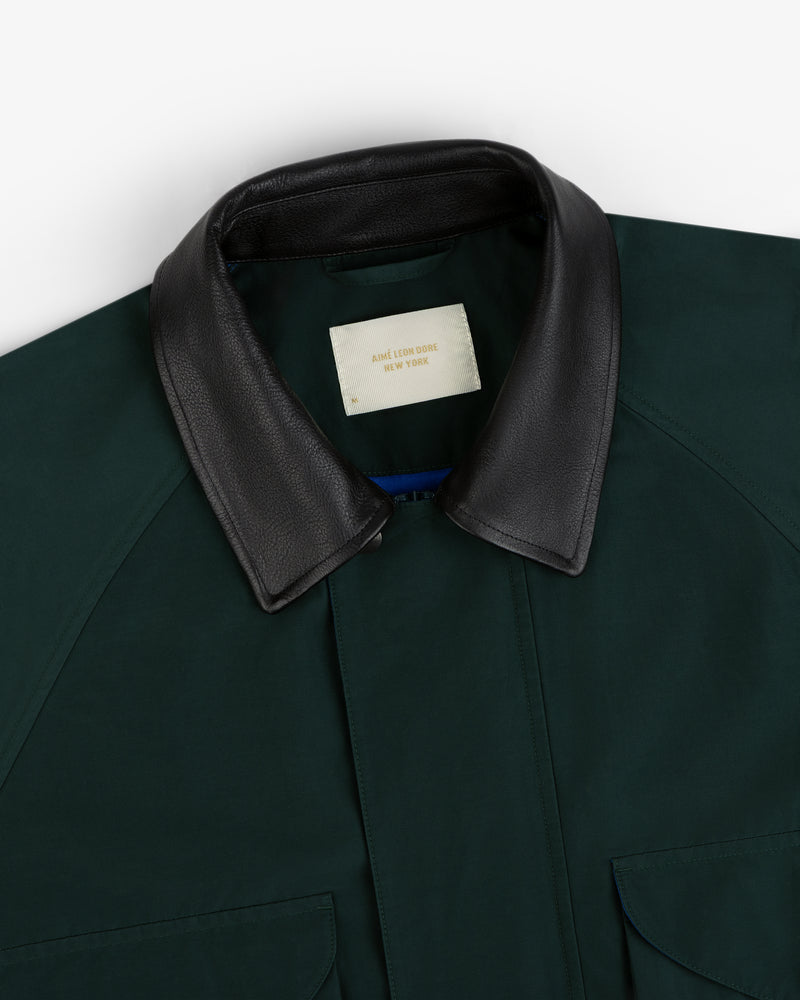 Dark green Lightweight Barn Jacket with black leather collar and cream Aime Leon Dore New York label.
