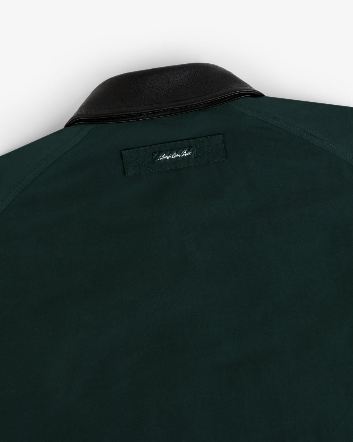 Lightweight Barn Jacket in dark green with black leather collar and small stitched label below the back collar.