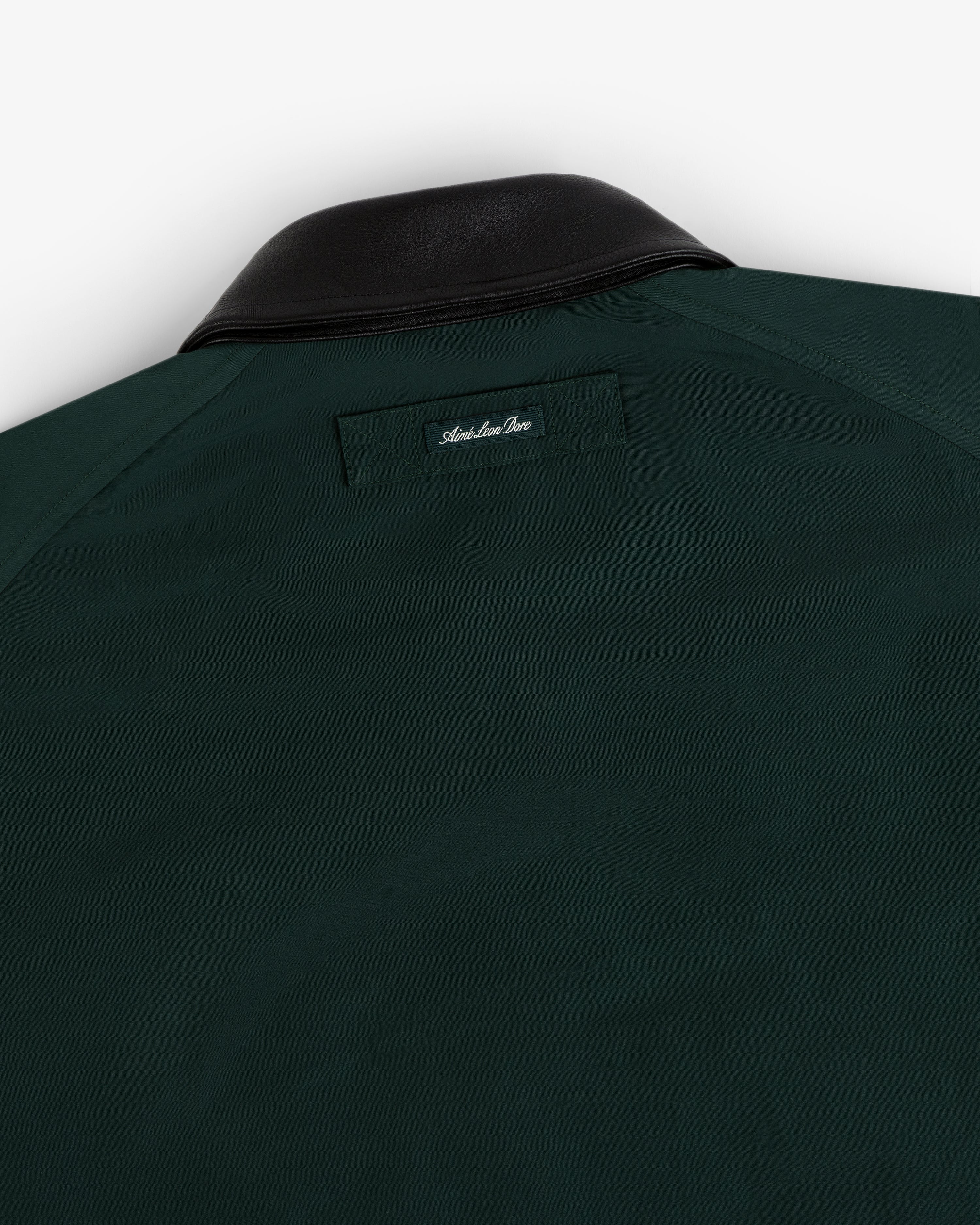 Lightweight Barn Jacket in dark green with black leather collar and small stitched label below the back collar.