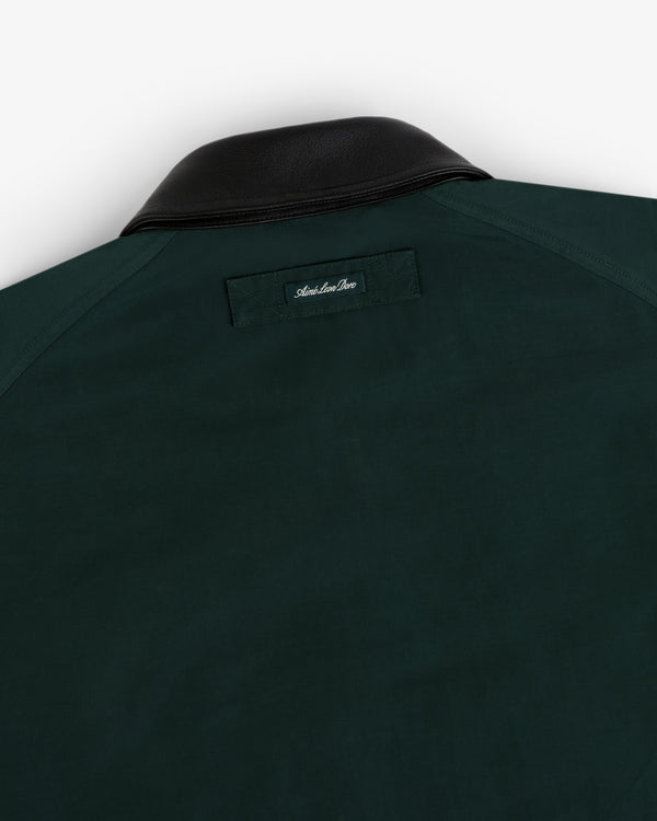 Lightweight Barn Jacket in dark green with black leather collar and small stitched label below the back collar.