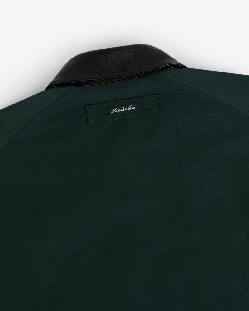 Lightweight Barn Jacket in dark green with black leather collar and small stitched label below the back collar.
