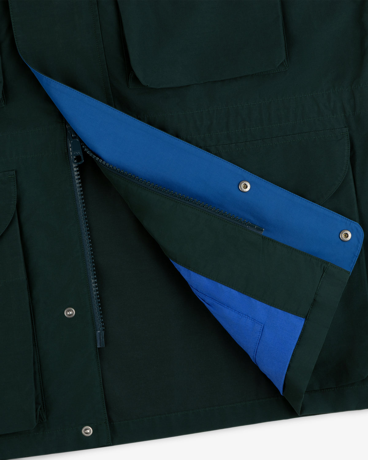 Lightweight Barn Jacket in dark green with a partially unzipped flap, revealing a bright blue lining.