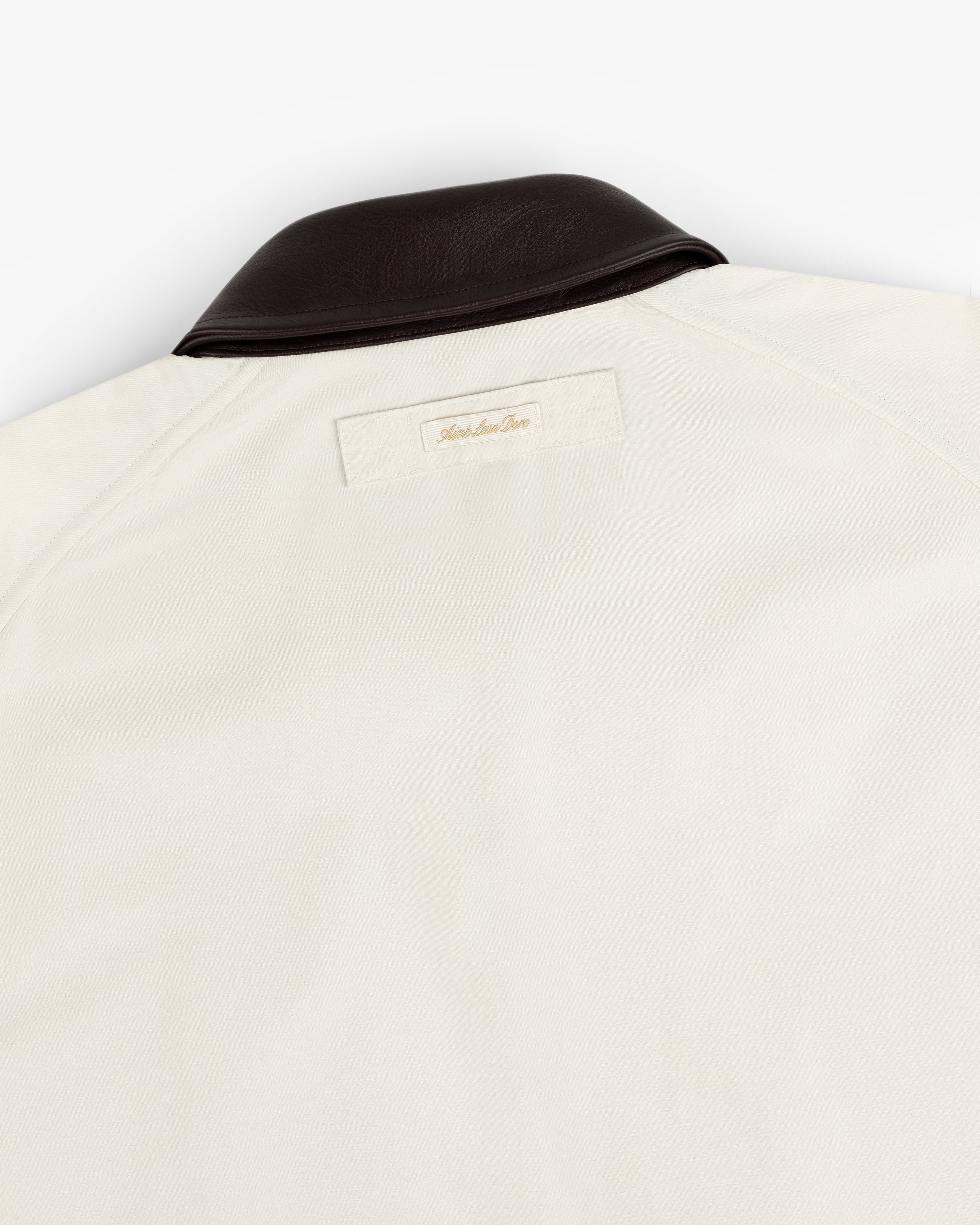 Lightweight Barn Jacket in cream with dark brown collar and rectangular back label near the neck.