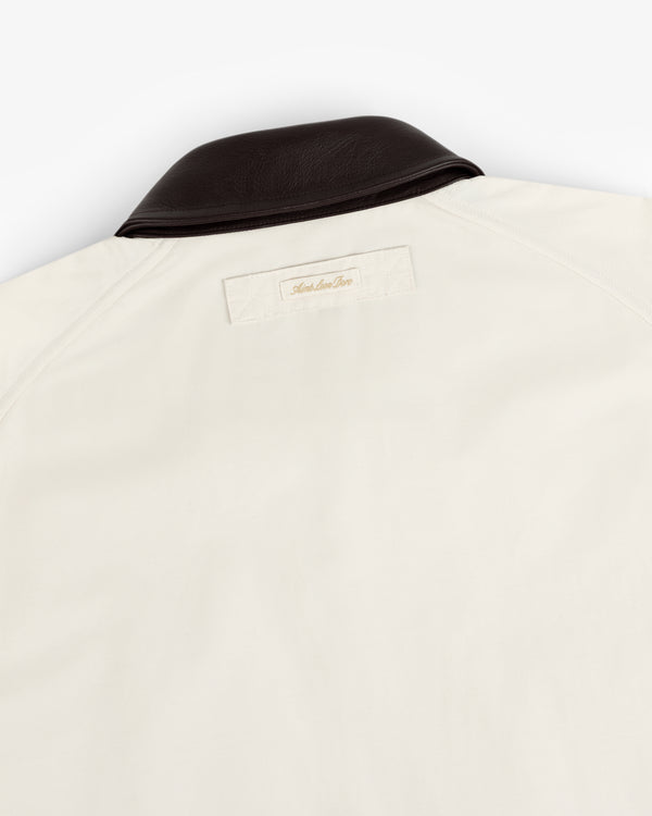 Lightweight Barn Jacket in cream with dark brown collar and rectangular back label near the neck.