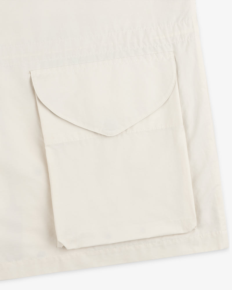 A close-up of the Lightweight Barn Jacket in cream, featuring a large, flap pocket on the fabric.