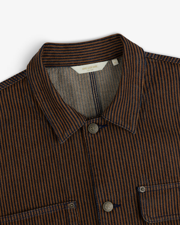 Hickory Stripe Denim Trucker Jacket in brown and navy stripes, collared with buttons and chest pockets, shoulder-up view.