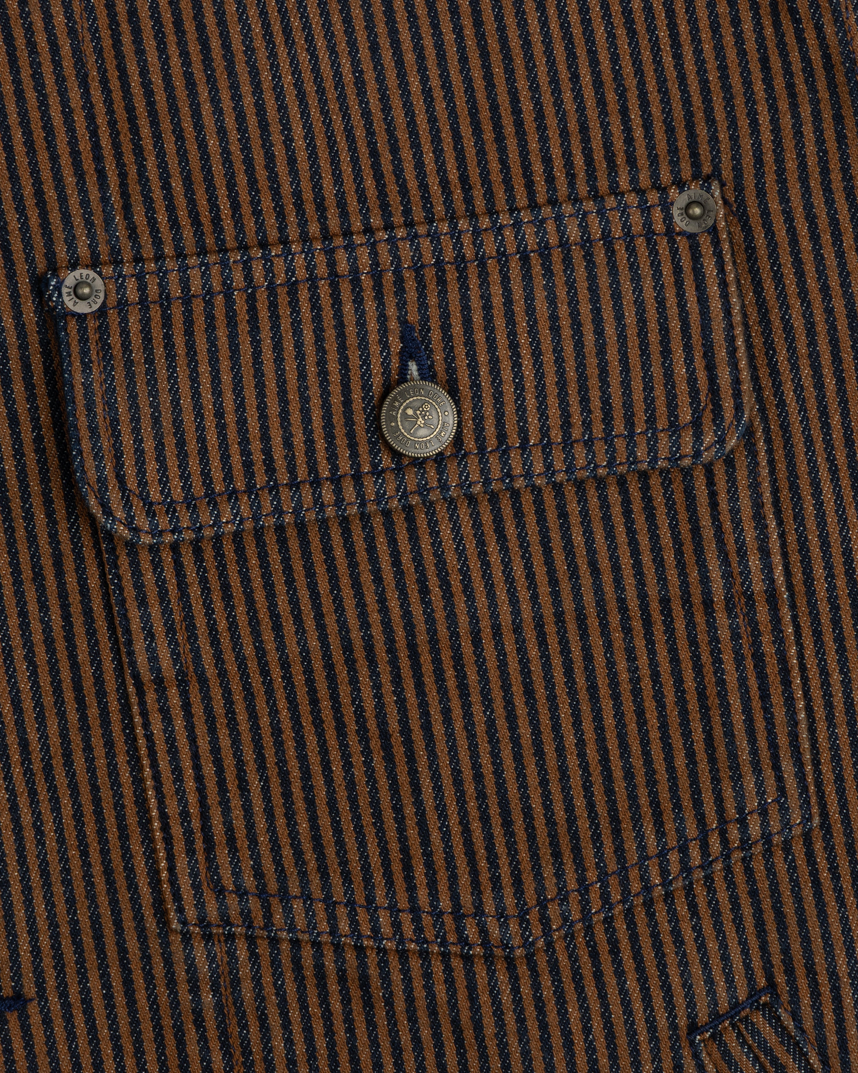 Hickory Stripe Denim Trucker Jacket: brown/navy vertical stripes, buttoned pocket, two metal fasteners.