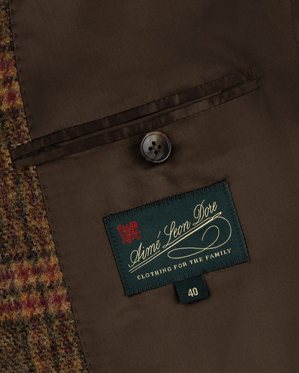 Interior of a Single-Breasted Plaid Tweed Suit Jacket with a brown lining, buttoned breast pocket, and size 40 brand label.