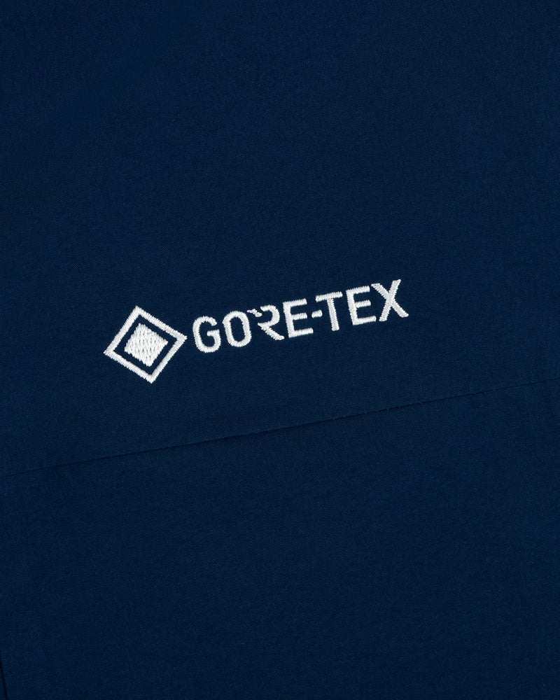 Navy blue Yankees GORE-TEX Rain Delay Jacket with white embroidered logo and diamond icon.