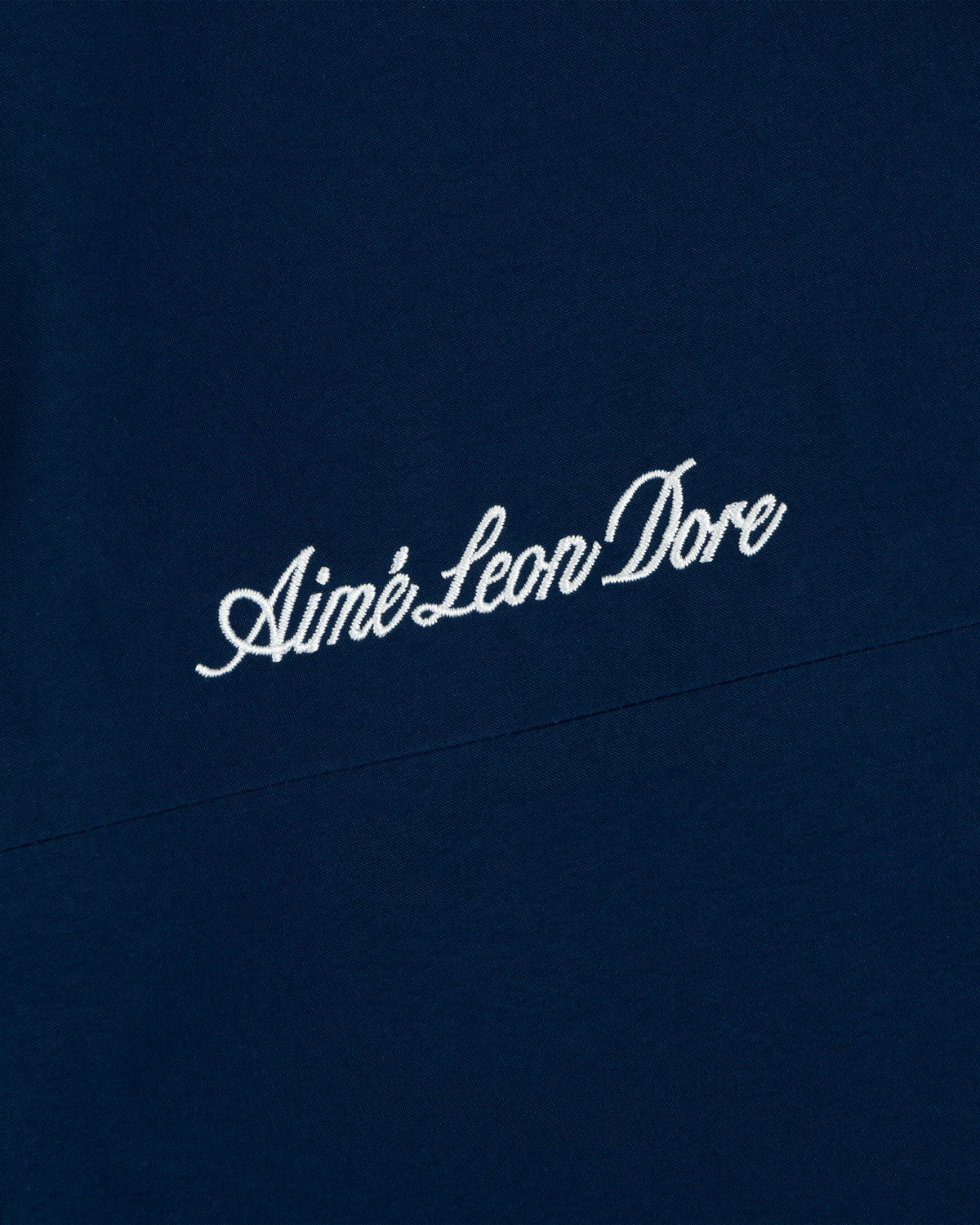 Yankees GORE-TEX Rain Delay Jacket features Aimé Leon Dore in white script on dark blue fabric.