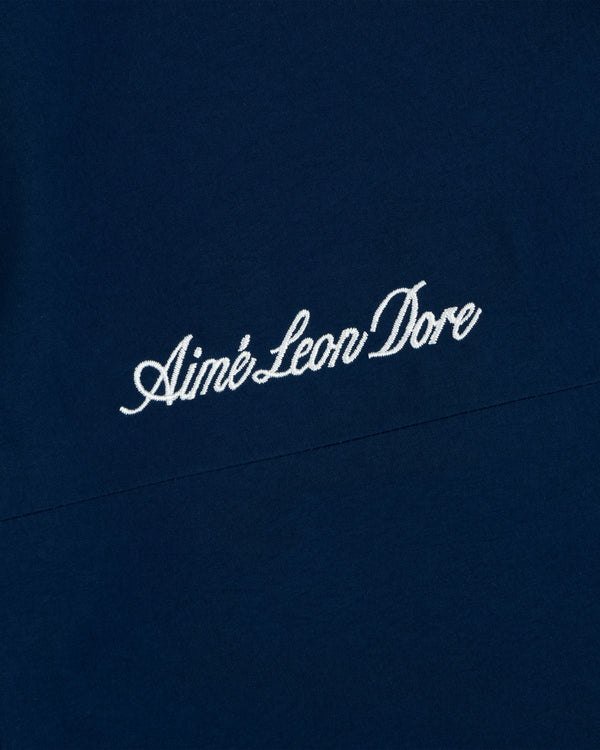 Yankees GORE-TEX Rain Delay Jacket features Aimé Leon Dore in white script on dark blue fabric.