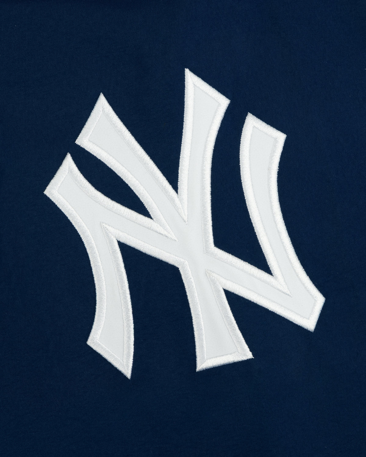 Yankees GORE-TEX Rain Delay Jacket with a white NY logo on dark blue, featuring the iconic team emblem.