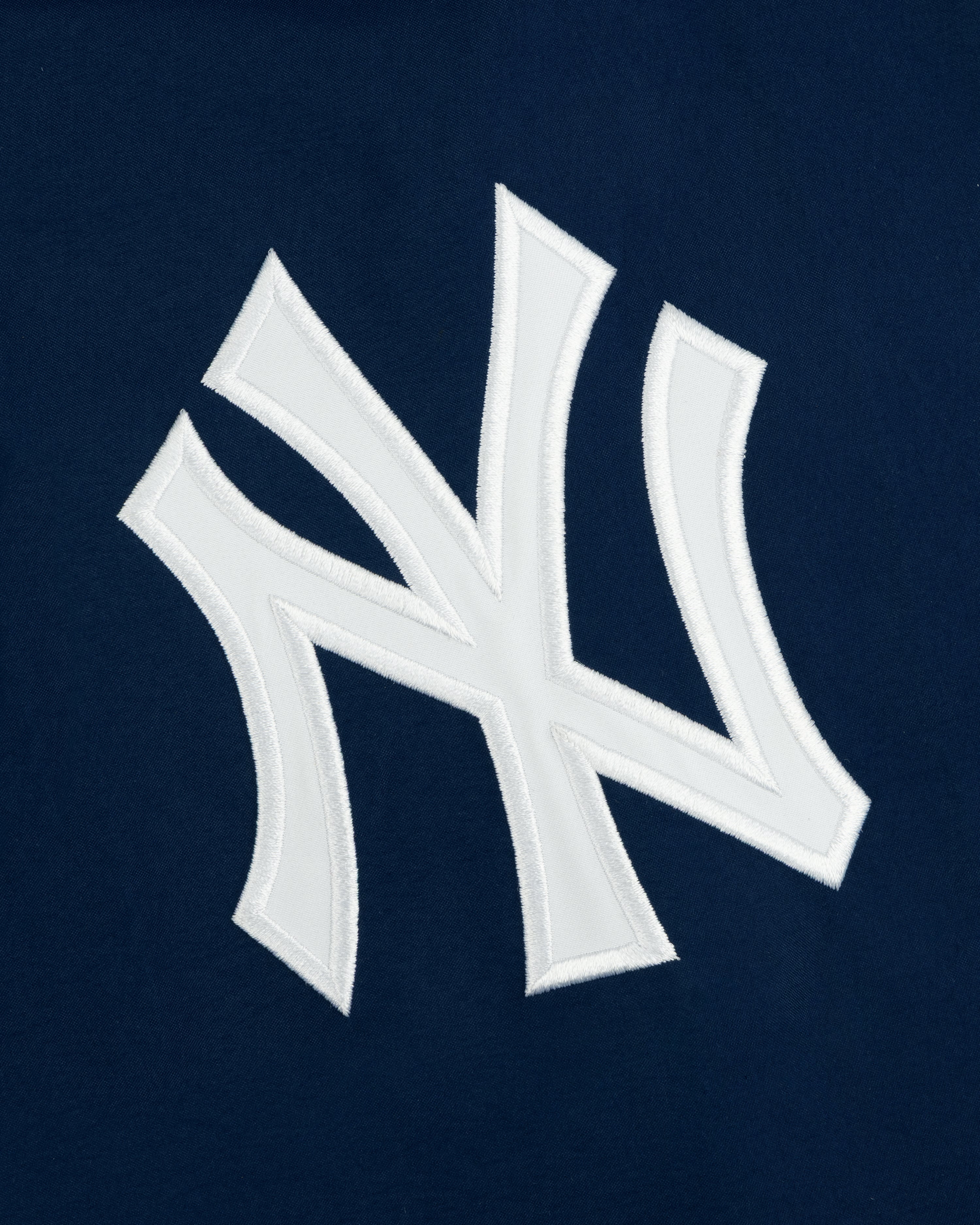 Yankees GORE-TEX Rain Delay Jacket with a white NY logo on dark blue, featuring the iconic team emblem.
