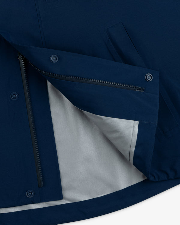Close-up of Yankees GORE-TEX Rain Delay Jacket’s side, showing zipper, buttons, and light grey inner lining.