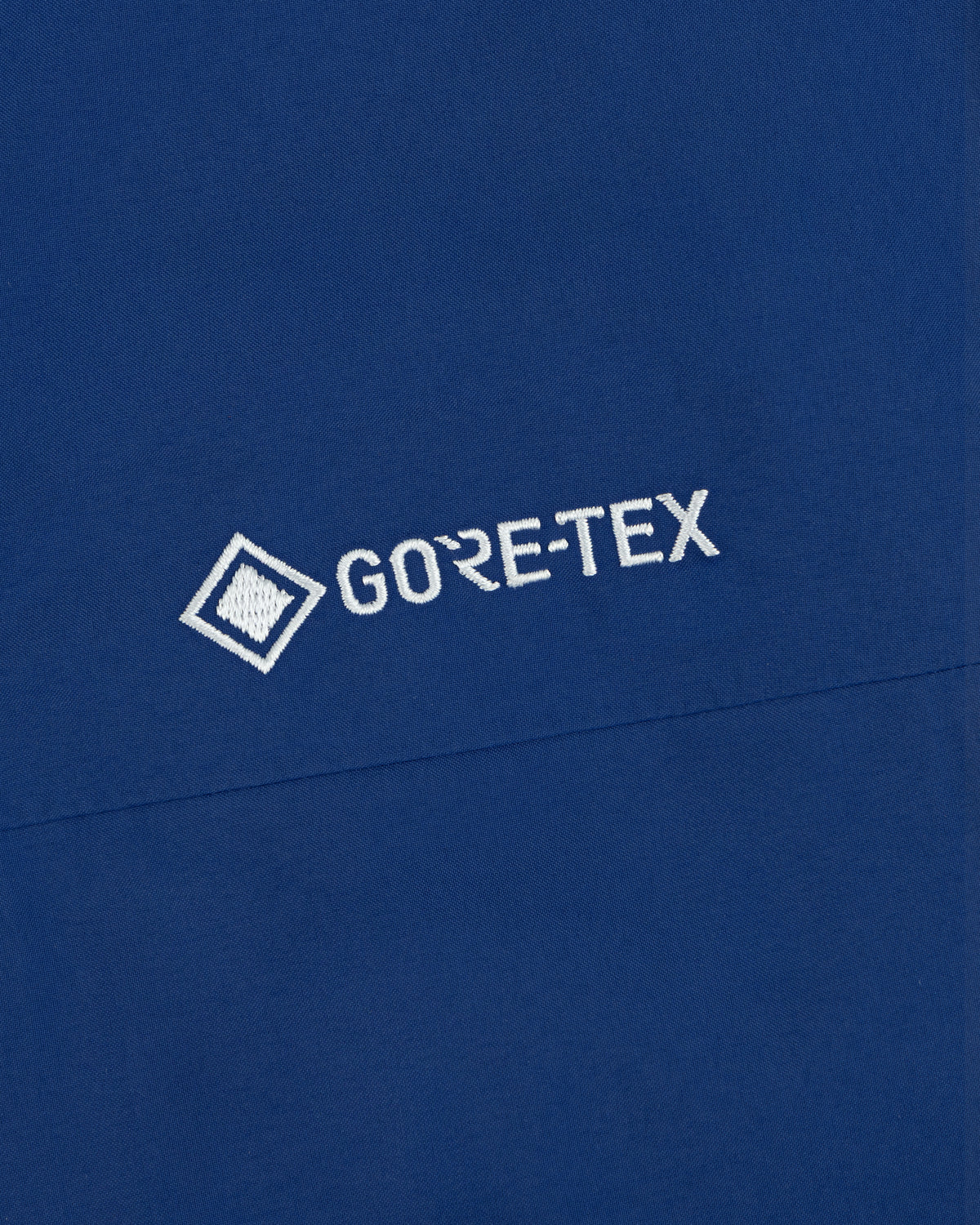 Blue Dodgers GORE-TEX Rain Delay Jacket with white logo and small square graphic left of the text.
