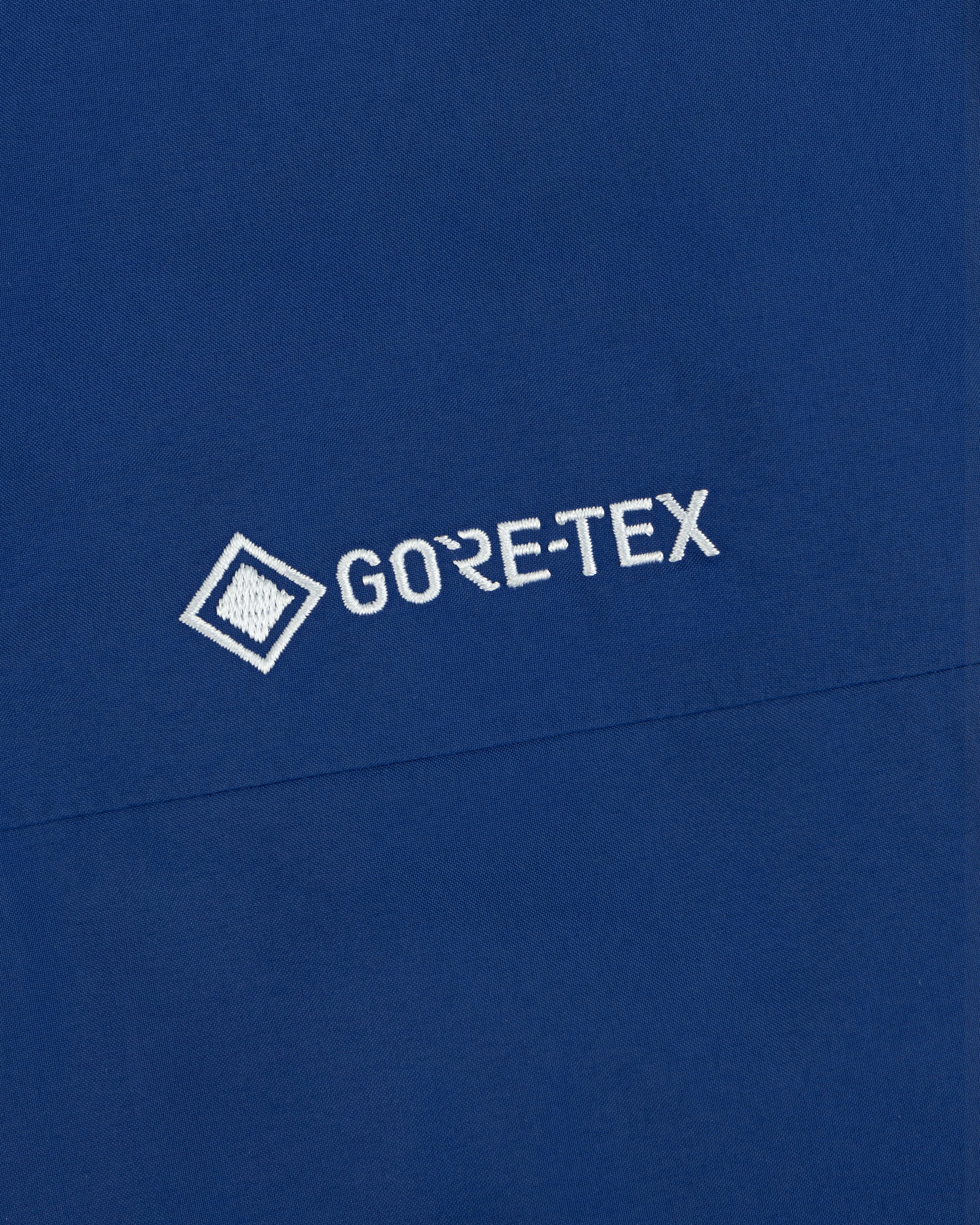 Blue Dodgers GORE-TEX Rain Delay Jacket with white logo and small square graphic left of the text.