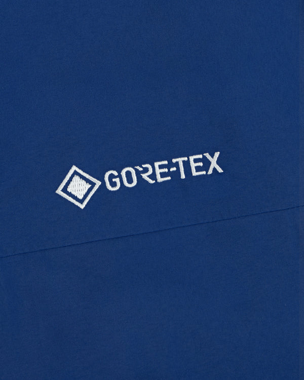 Blue Dodgers GORE-TEX Rain Delay Jacket with white logo and small square graphic left of the text.