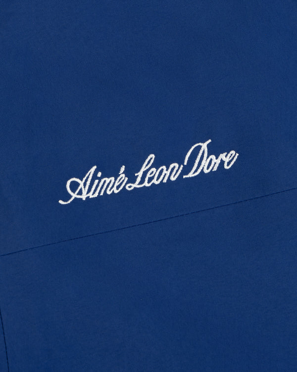 Close-up of blue Dodgers GORE-TEX Rain Delay Jacket with Aimé Leon Dore embroidered in white cursive letters.