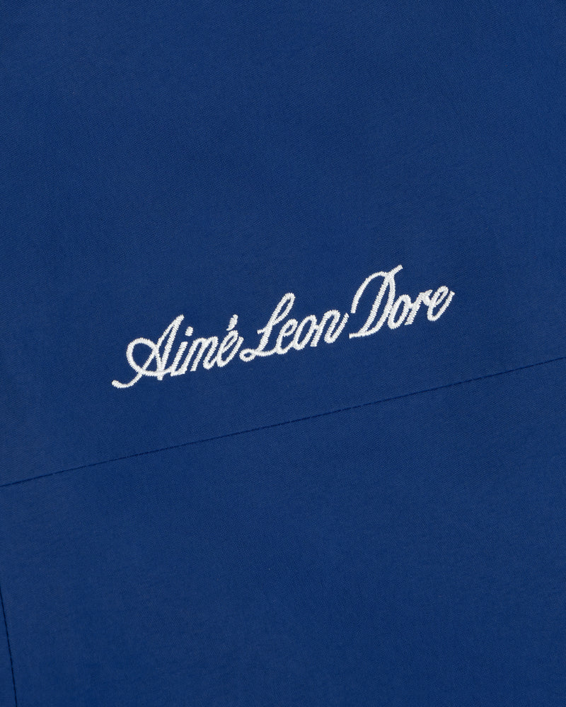 Close-up of blue Dodgers GORE-TEX Rain Delay Jacket with Aimé Leon Dore embroidered in white cursive letters.