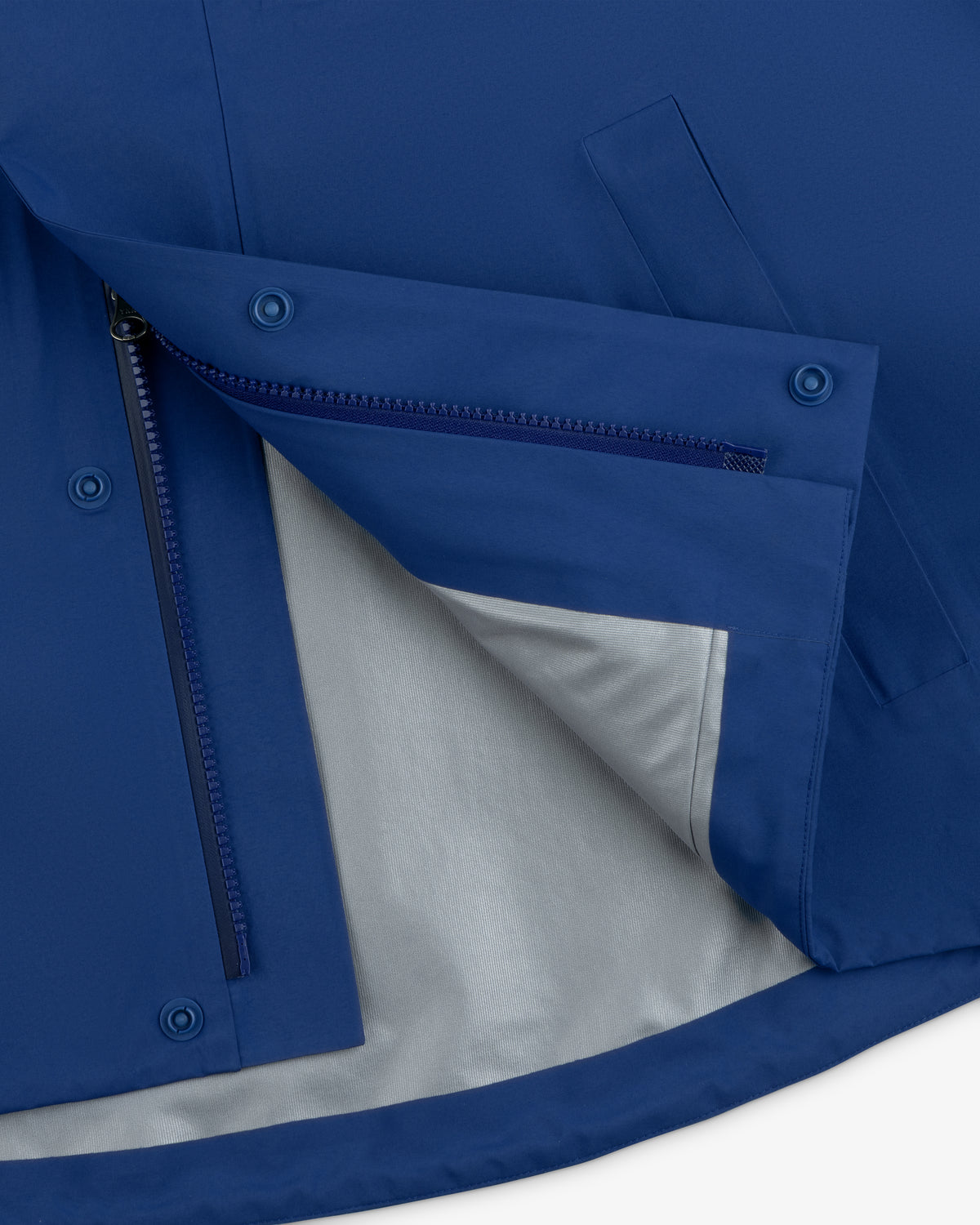 Close-up of the Dodgers GORE-TEX Rain Delay Jacket’s blue lining, with zippered pocket and snap buttons.