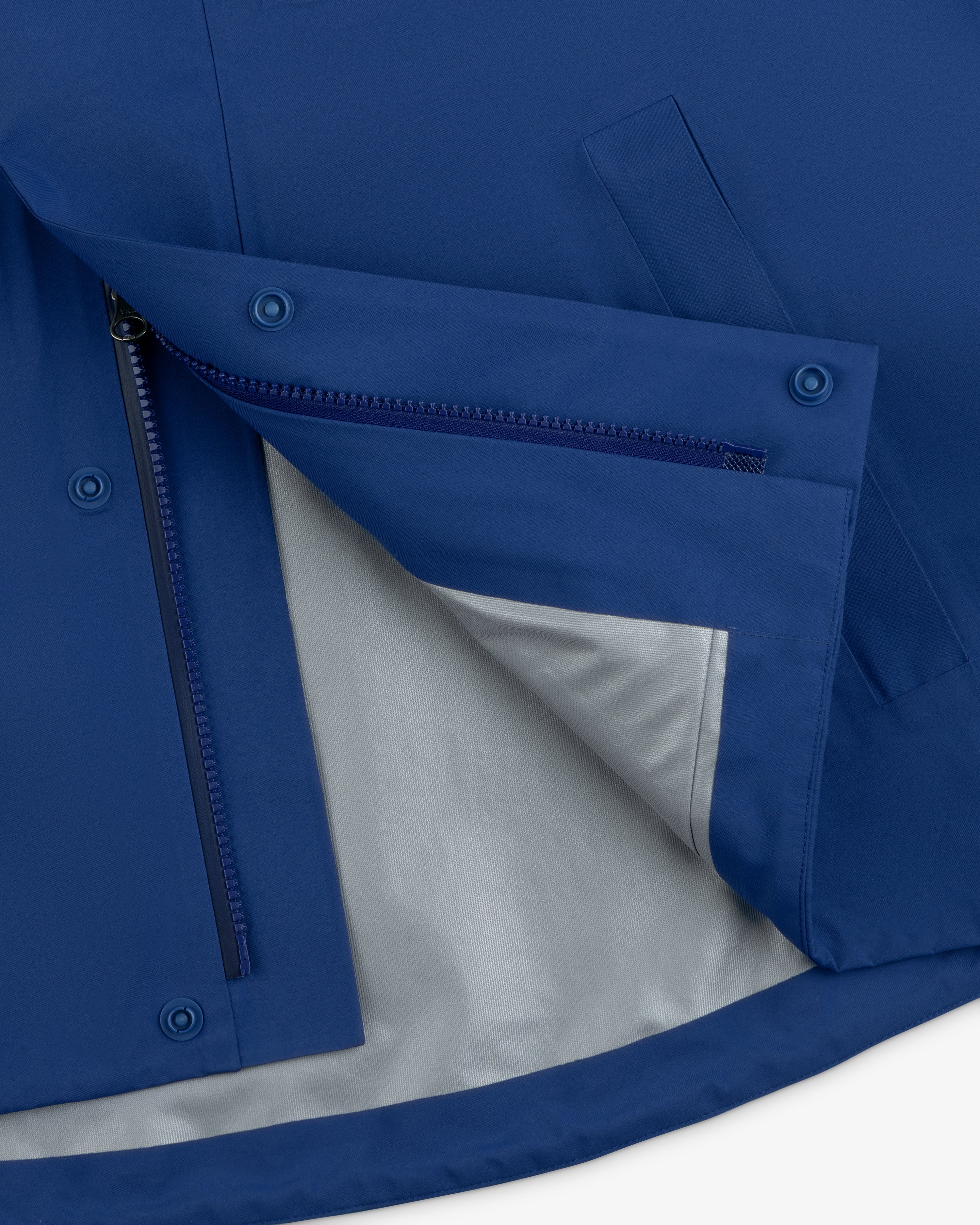 Close-up of the Dodgers GORE-TEX Rain Delay Jacket’s blue lining, with zippered pocket and snap buttons.