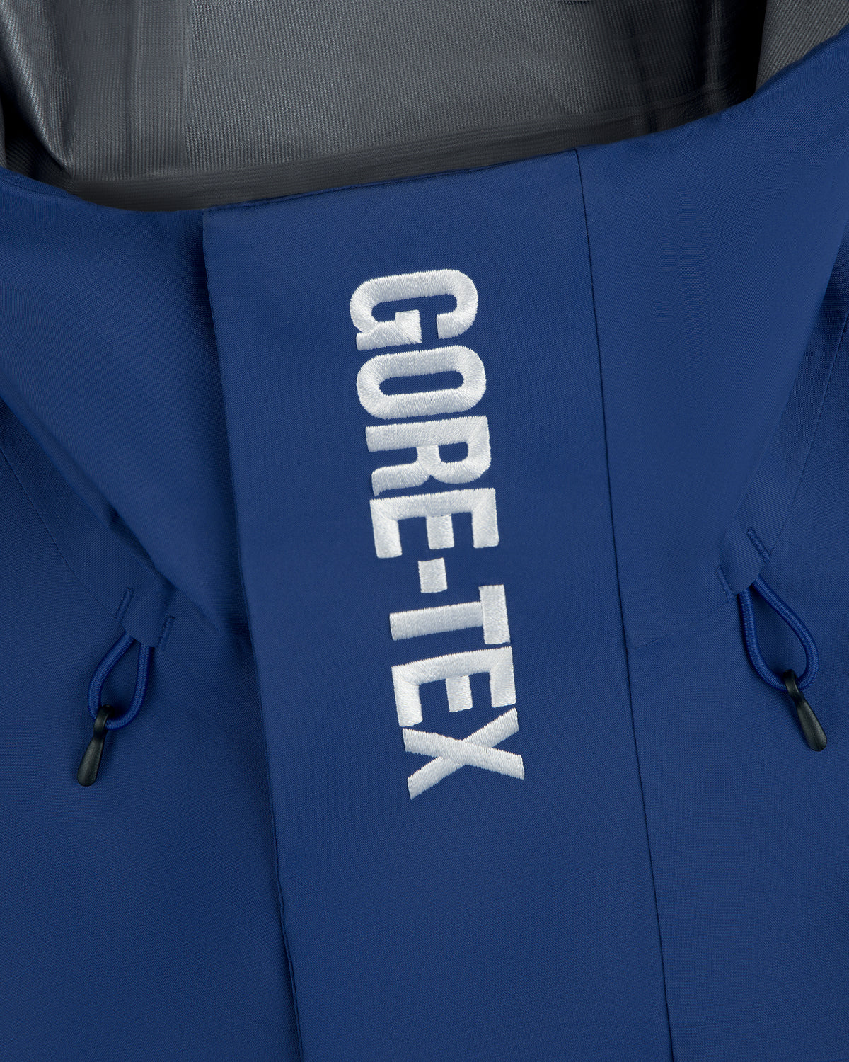Close-up of Dodgers GORE-TEX Rain Delay Jacket with white GORE-TEX lettering on the front flap.
