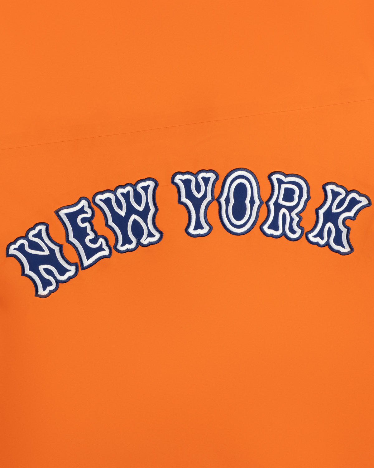 Mets GORE-TEX Rain Delay Jacket: “NEW YORK” in wavy blue & white letters on an orange background.