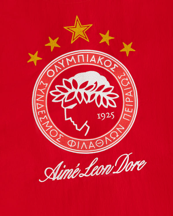 ALD / Olympiacos F.C. Nylon Quarter Zip Pullover with an embroidered crest on red fabric.