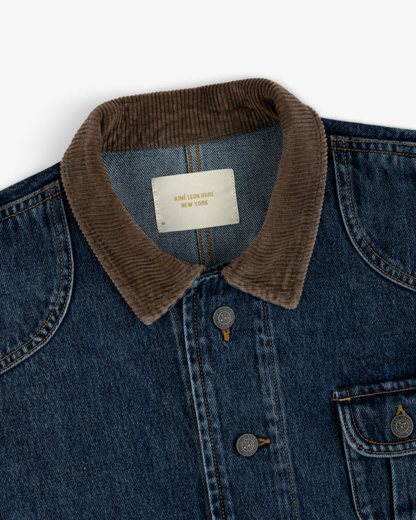 Denim Chore Coat in dark blue denim with a brown corduroy collar and branded metal buttons.