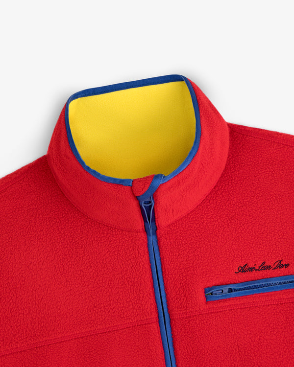 Script Fleece Half Zip Pullover in red with a yellow inner collar and blue zipper trim.