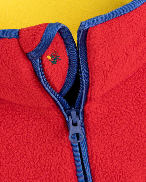Script Fleece Half Zip Pullover in red fleece with blue trim and small floral embroidery near the collar.