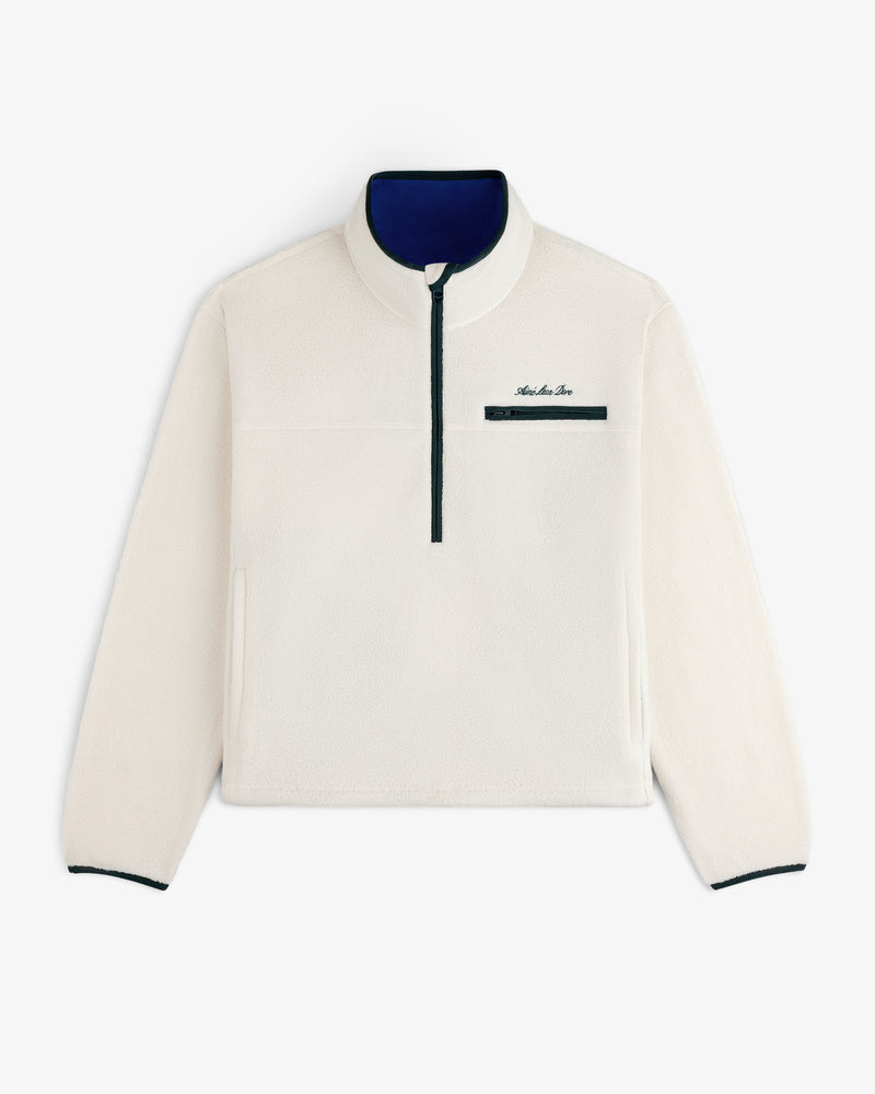Script Fleece Half Zip Pullover in off-white fleece with a navy blue zippered chest pocket and blue inner collar.