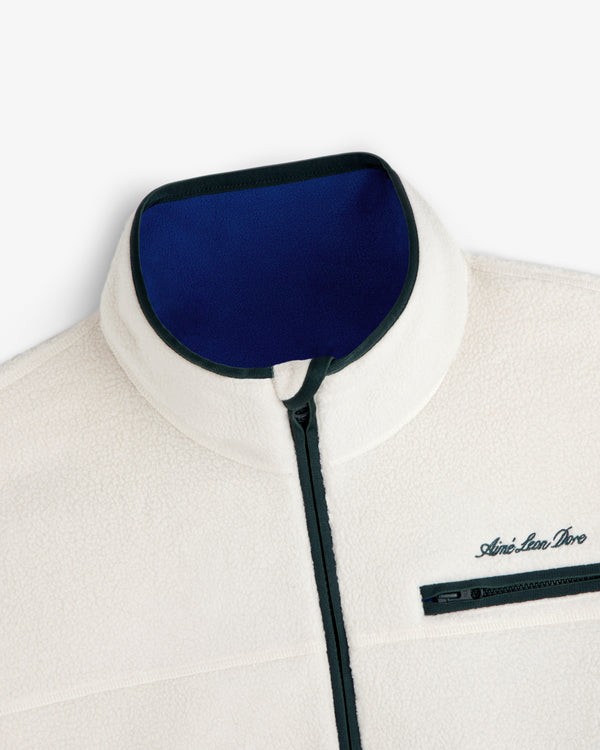 Off-white Script Fleece Half Zip Pullover with a blue inner collar, dark trim, and a zippered chest pocket.