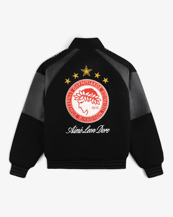 Back view of a black ALD / Olympiacos F.C. Team Leather Jacket with a team logo, gold stars, and script text.