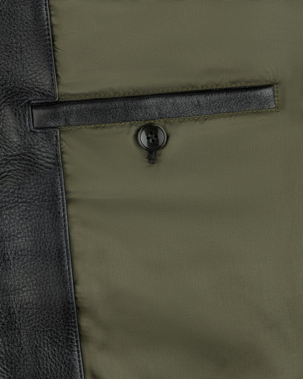 Interior pocket of a Napa Leather Bomber Jacket with a button closure against an olive lining.