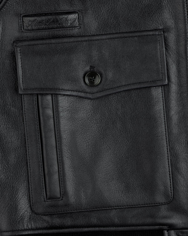Close-up of a Napa Leather Bomber Jacket pocket with a flap, button closure, and a vertical slit pocket detail.