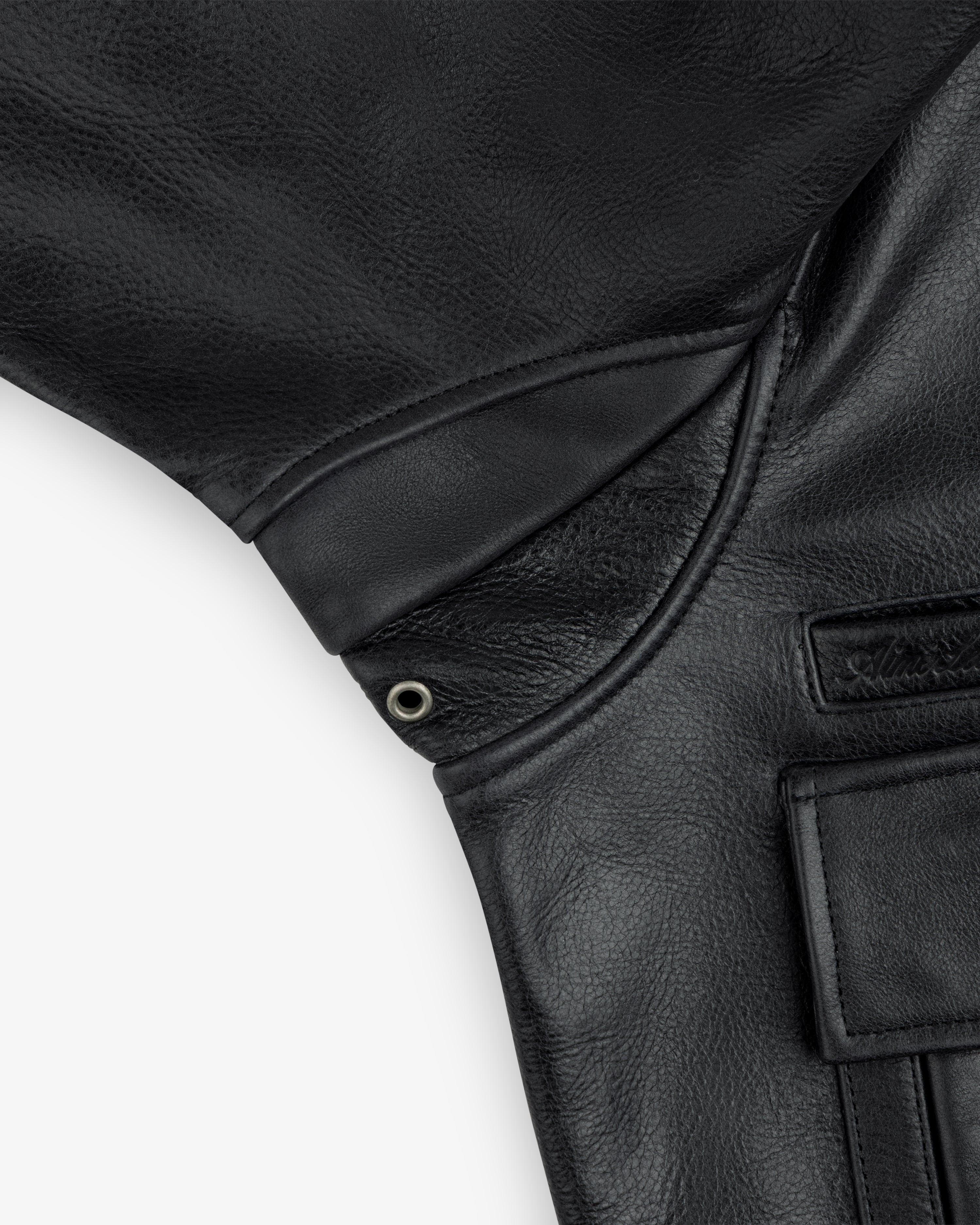 Close-up of the Napa Leather Bomber Jacket underarm and pocket, featuring a reinforced gusset with a metal grommet.