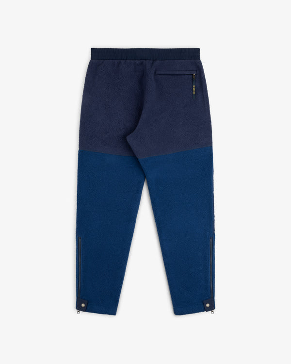ALD / The North Face Denali Fleece Pant in blue, elastic waist, back zip pocket, ankle zips, shown flat on white.